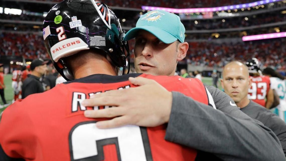 Atlanta Falcons quarterback Matt Ryan (2) embraces Miami Dolphins head coach Adam Gase after an NFL football game, Sun., Oct. 15, 2017, in Atlanta. The Miami Dolphins won 20-17.