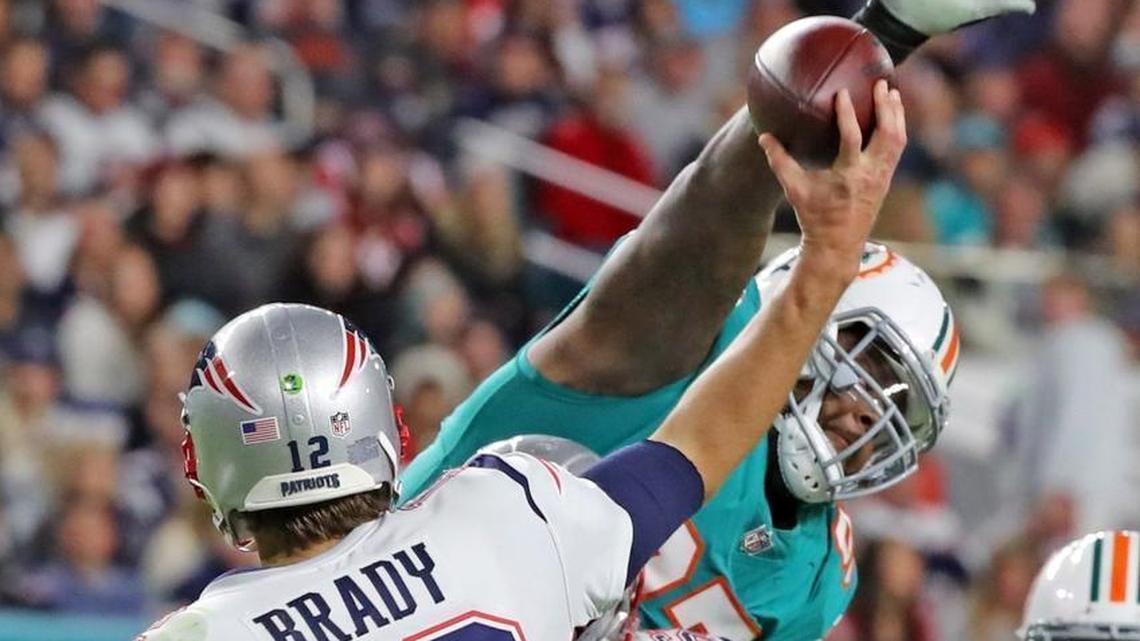 Miami Dolphins defensive tackle Jordan Phillips (97) reaches to block New England Patriots quarterback Tom Brady’s pass in a game last December. Phillips will assume a more prominent role after the release of Ndamukong Suh.