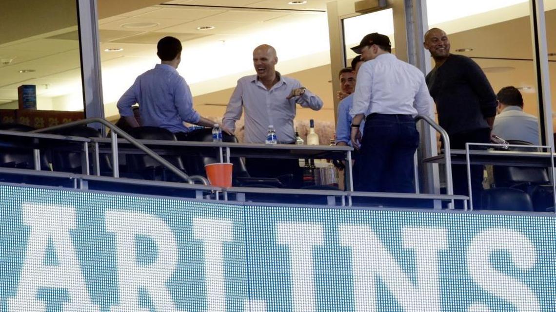 Derek Jeter, right, stands outside of a suite after a baseball game between the Miami Marlins and the Atlanta Braves, Sun., Oct. 1, 2017, at Marlins Park in Miami. Major league owners unanimously approved the sale of the Marlins on Wednesday to an investment group led by Jeter and Bruce Sherman.