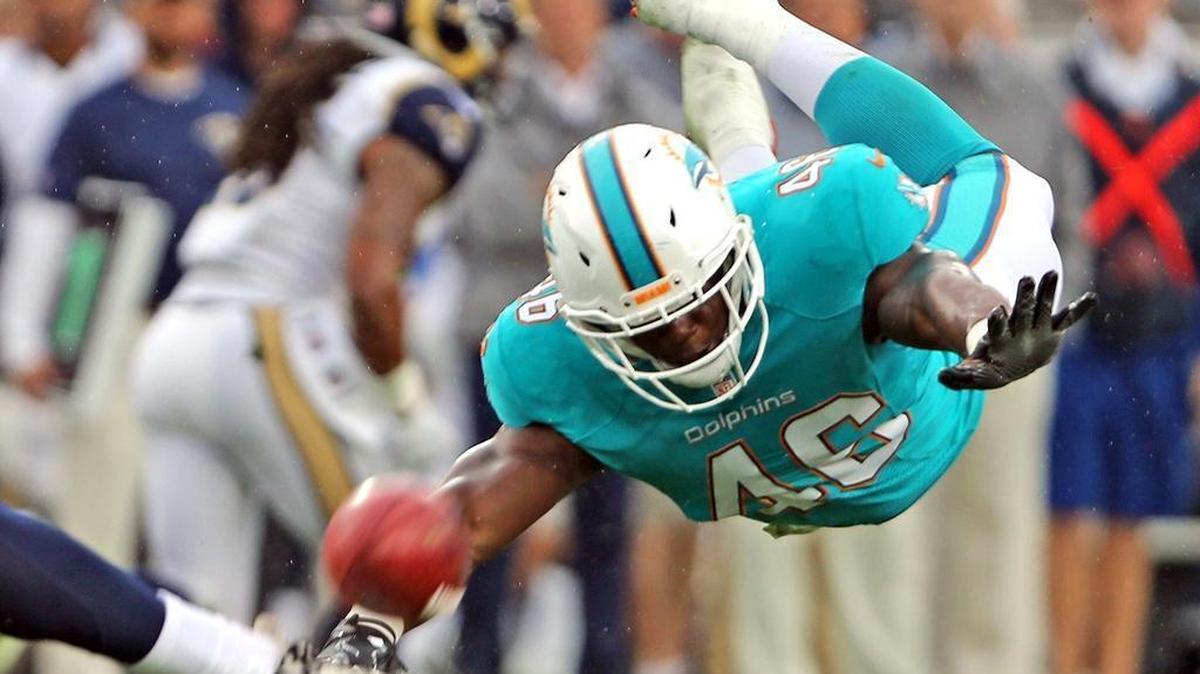 Miami Dolphins linebacker Neville Hewitt, rushing the kicker in this game against the Rams last November, was promoted from the practice squad to the 53-man roster on Wednesday.