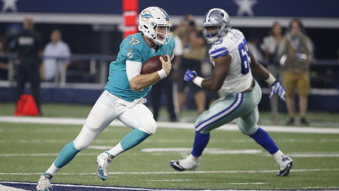 Miami Dolphins quarterback Ryan Tannehill runs the ball as Dallas Cowboys defensive end Shaneil Jenkins (69) watches during an NFL preseason football game, Fri., Aug. 19, 2016, in Arlington, Texas.