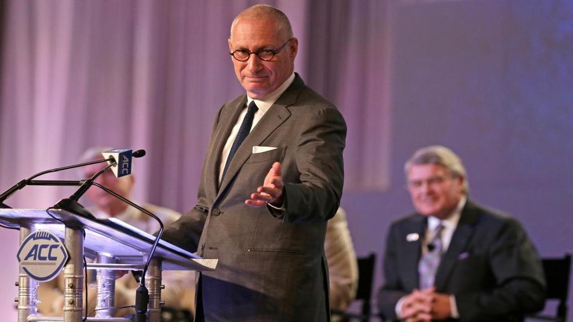 ESPN president John Skipper gestures as he talks about the new ACC/ESPN Network during a news conference at the Atlantic Coast Conference Football Kickoff in Charlotte, N.C., Thurs., July 21, 2016. ACC commissioner John Swofford listens at rear right.