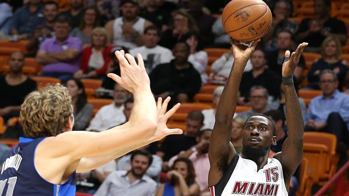 Miami Heat forward Okaro White shoots to the basket against Mavericks' forward Dirk Nowitzki in the second quarter of the Miami Heat and Dallas Mavericks NBA game at AmericanAirlines Arena in Miami on Thurs., Jan. 19, 2017.