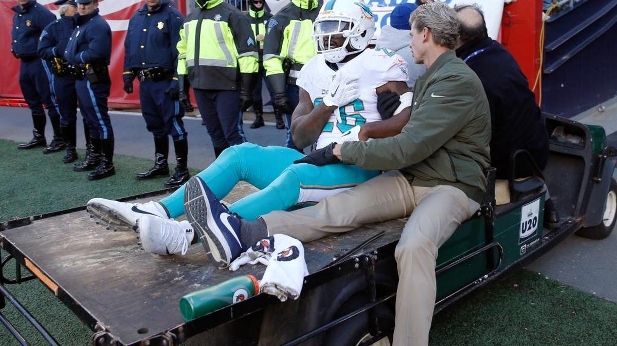 Miami Dolphins running back Damien Williams is carried from the field on a cart during the second half of Sunday’s game against New England. (AP Photo/Michael Dwyer)