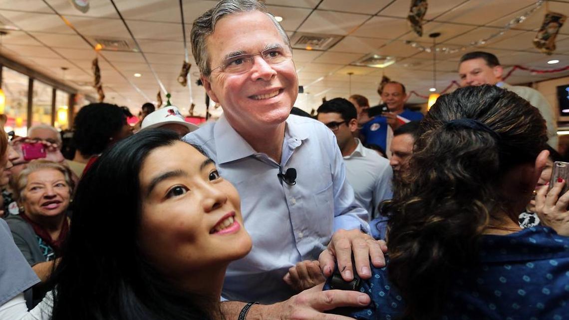 Presidential candidate Jeb Bush smiles for selfies with supportets at Chico's Cuban Restaurant in Hialeah on Monday Dec. 28, 2015 on his first leg of many campaign stops in Florida.