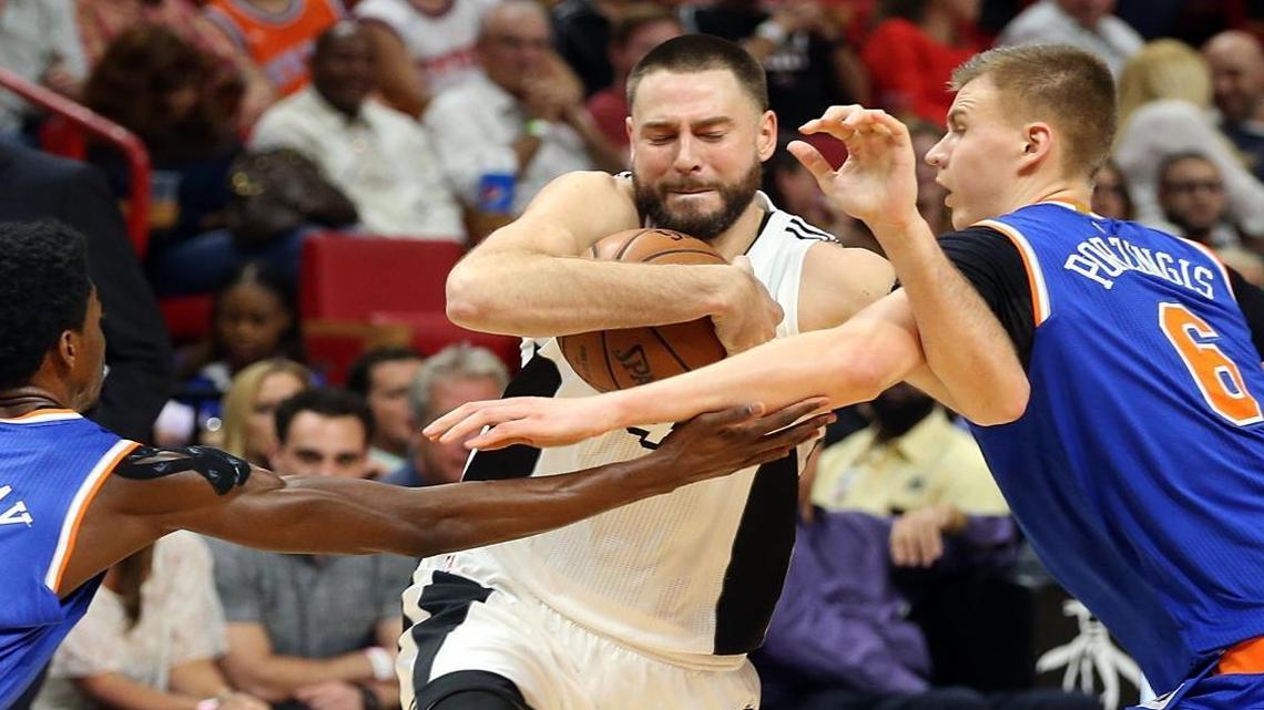 Miami Heat guard Josh McRoberts goes to the basket against Knicks' guard Justin Holiday (left) and forward Kristaps Porzingis in the fourth quarter of the Miami Heat and New York Knicks game at AmericanAirlines Arena in Miami on Tues., Dec. 6, 2016.