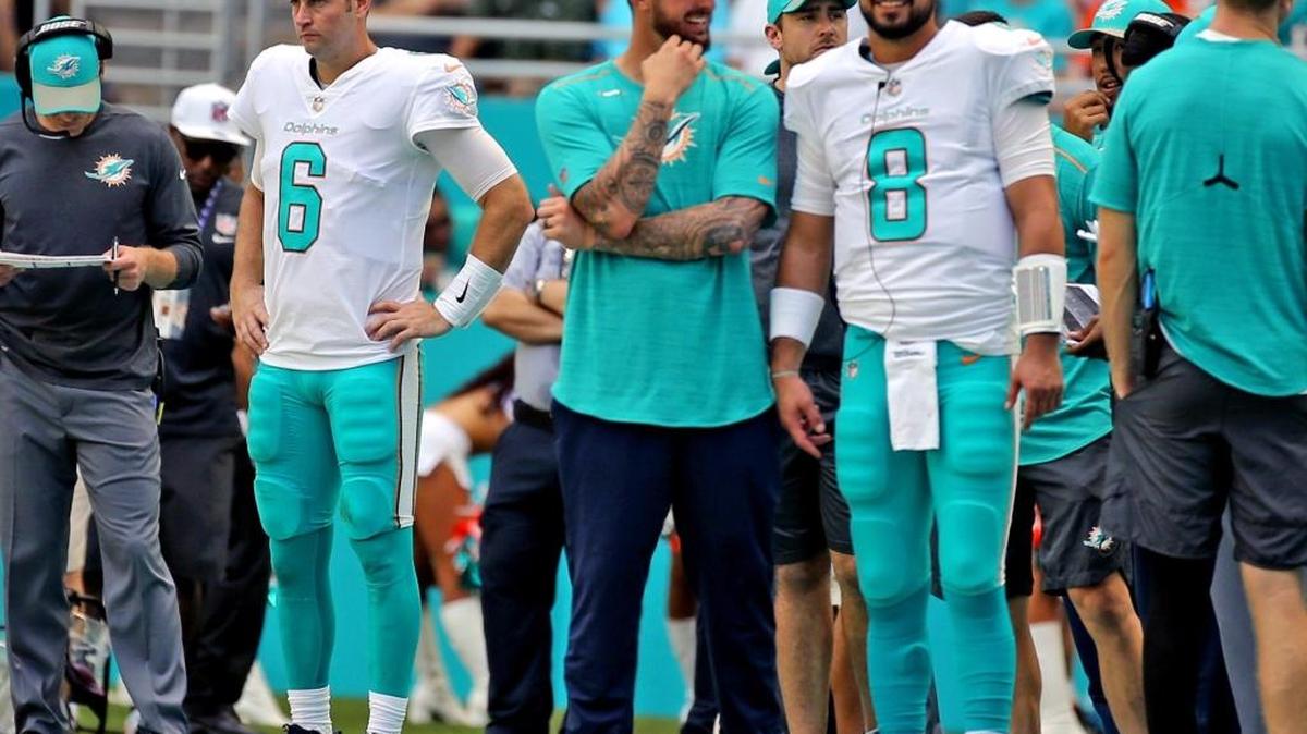 Miami Dolphins quarterback Jay Cutler (6) stands aside as Brandon Doughty and backup quarterback and Matt Moore (8) talk as they play the Tennessee Titans at Hard Rock Stadium in Miami Gardens, Florida, October 8, 2017.