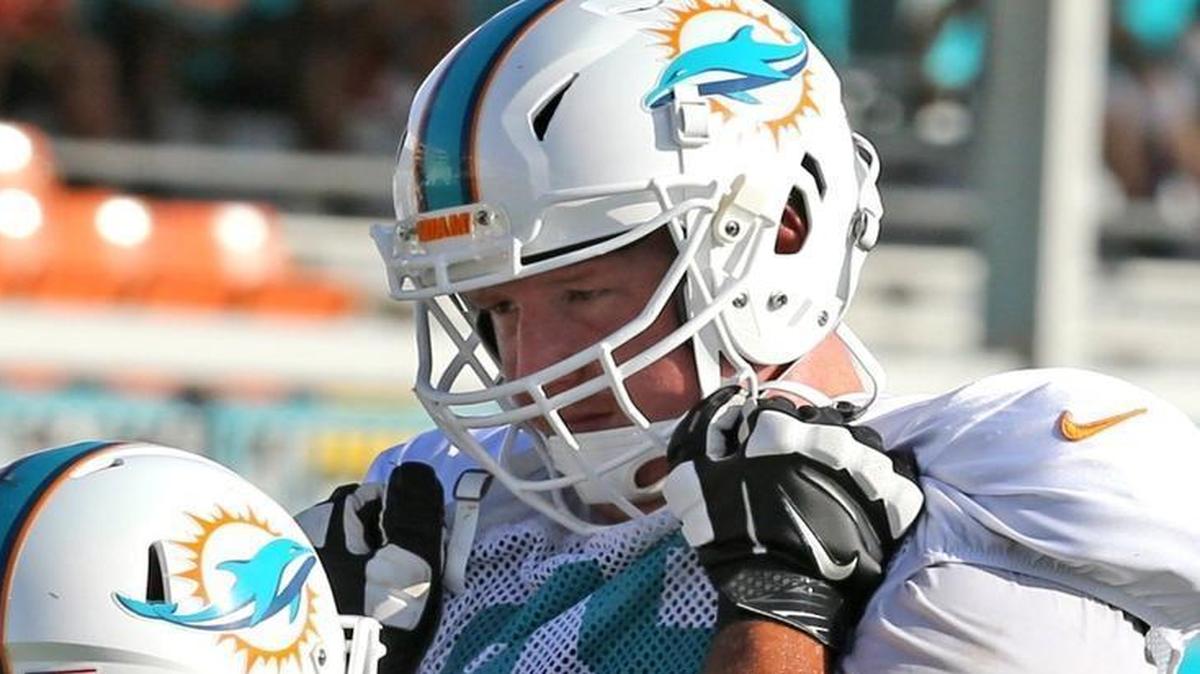 Guards Ulrick John, left, and Sam Young, right, at the Miami Dolphins training facility in Davie in August.