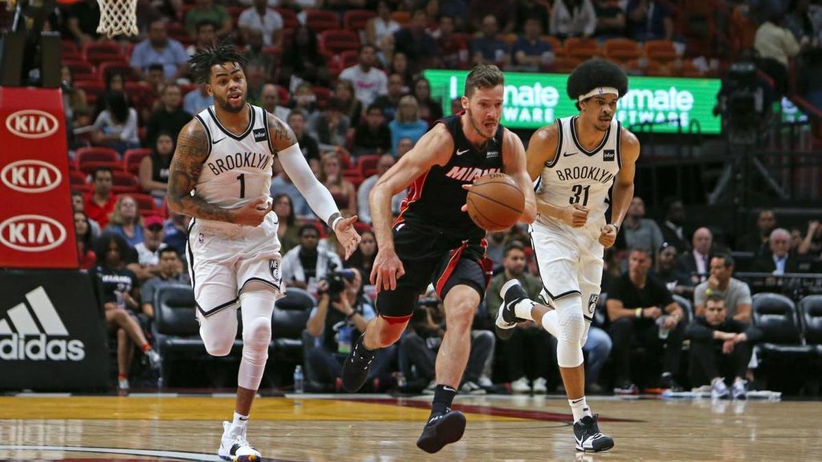 Miami Heat guard Goran Dragic drives against Brooklyn Nets guard D'Angelo Russell (1) and center Jarrett Allen (31) during the first quarter of Saturday’s game.