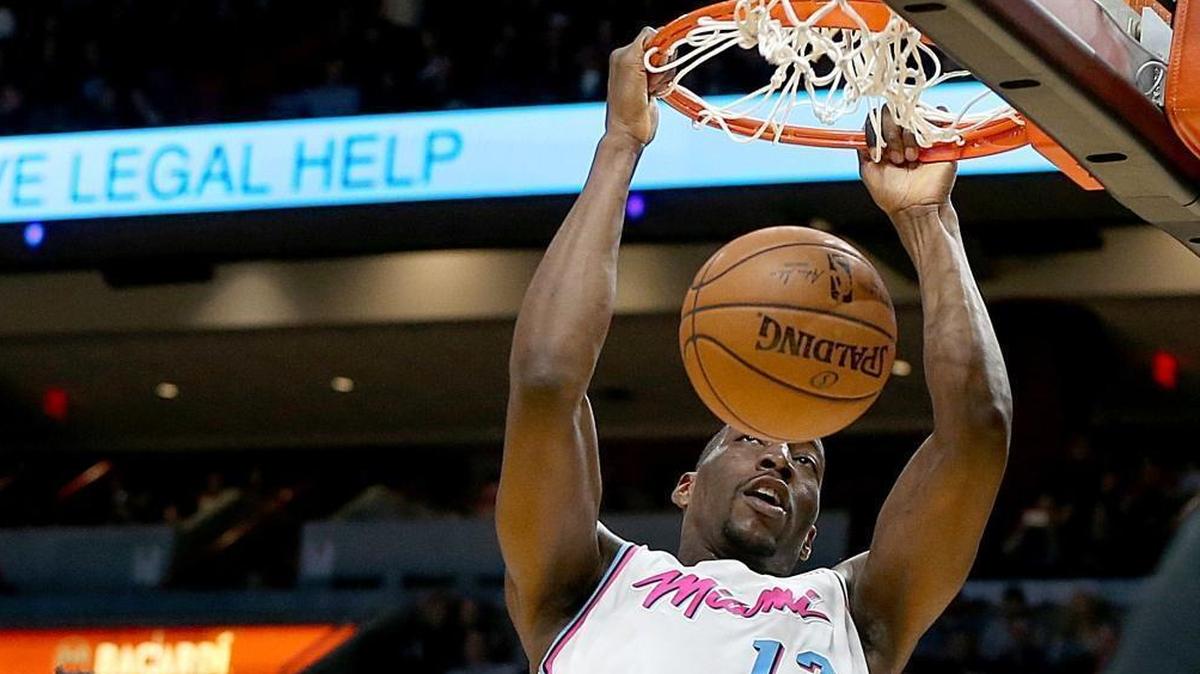 Heat center Bam Adebayo dunks over Kings’ forward Skal Labissiere, in the second quarter of game between the Miami Heat and Sacramento Kings at AmericanAirlines Arena in Miami on Thursday, Jan. 25, 2018.