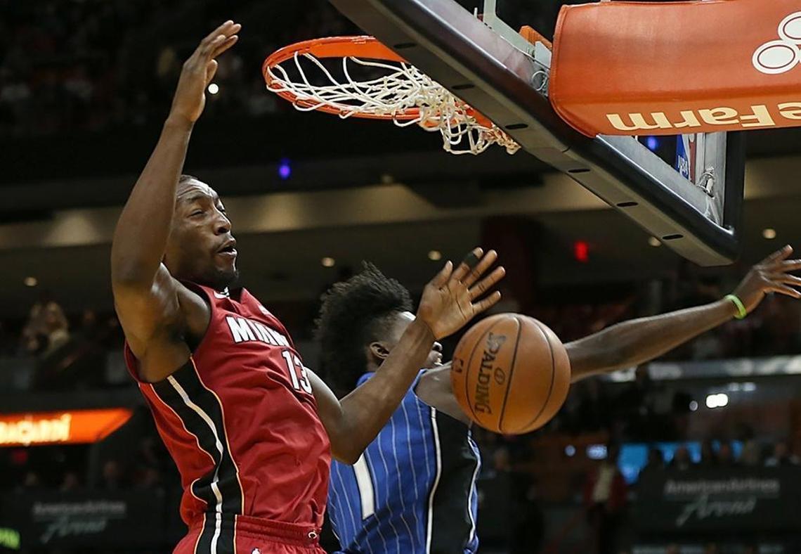 Miami Heat center Bam Adebayo dunks against Magic’s forward Jonathan Isaac in a game on Dec. 26.