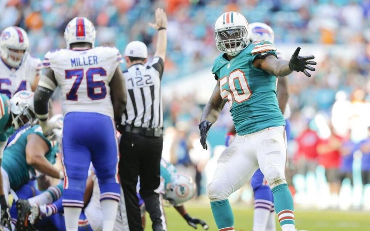 Miami Dolphins defensive end Andre Branch (50) celebrates after Buffalo Bills quarterback Tyrod Taylor (5) is sacked by Miami defensive end Cameron Wake (91) in the fourth quarter as the Miami Dolphins host the Buffalo Bills at Hard Rock Stadium on Sun., Oct. 23, 2016.