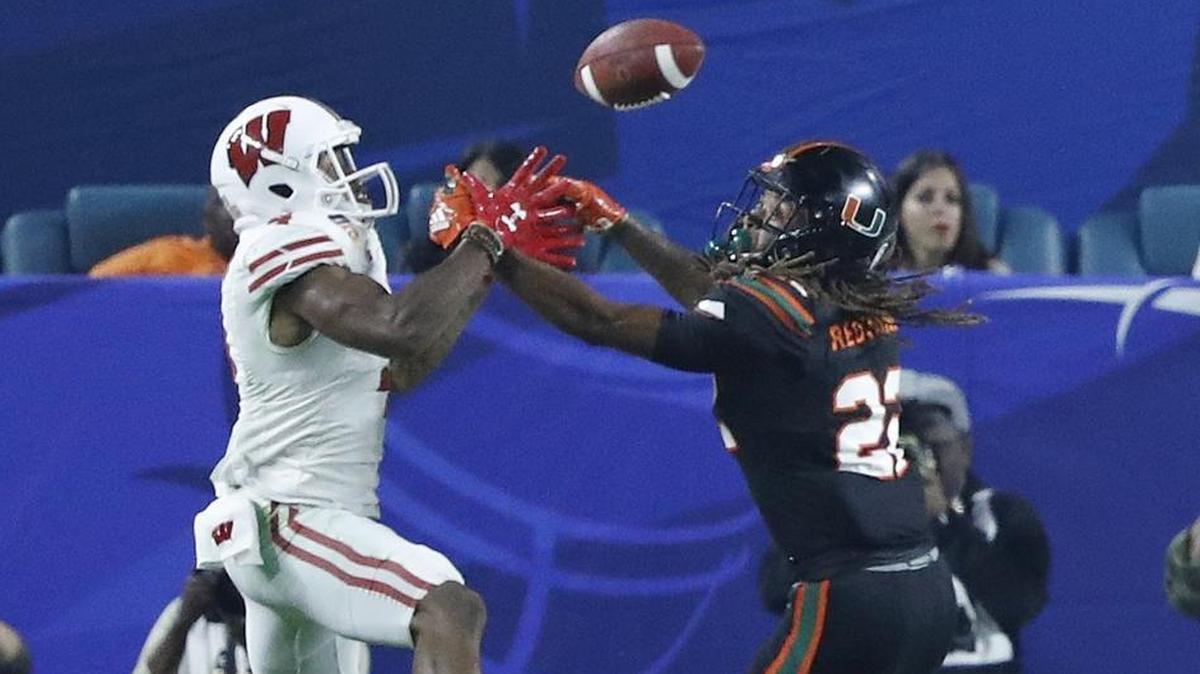 Wisconsin Badgers wide receiver A.J. Taylor (4) scores on a pass reception in the end zone as Miami Hurricanes defensive back Sheldrick Redwine (22) defends in the Orange Bowl last December. Redwine has had a good spring, UM defensive coordinator Manny Diaz said.