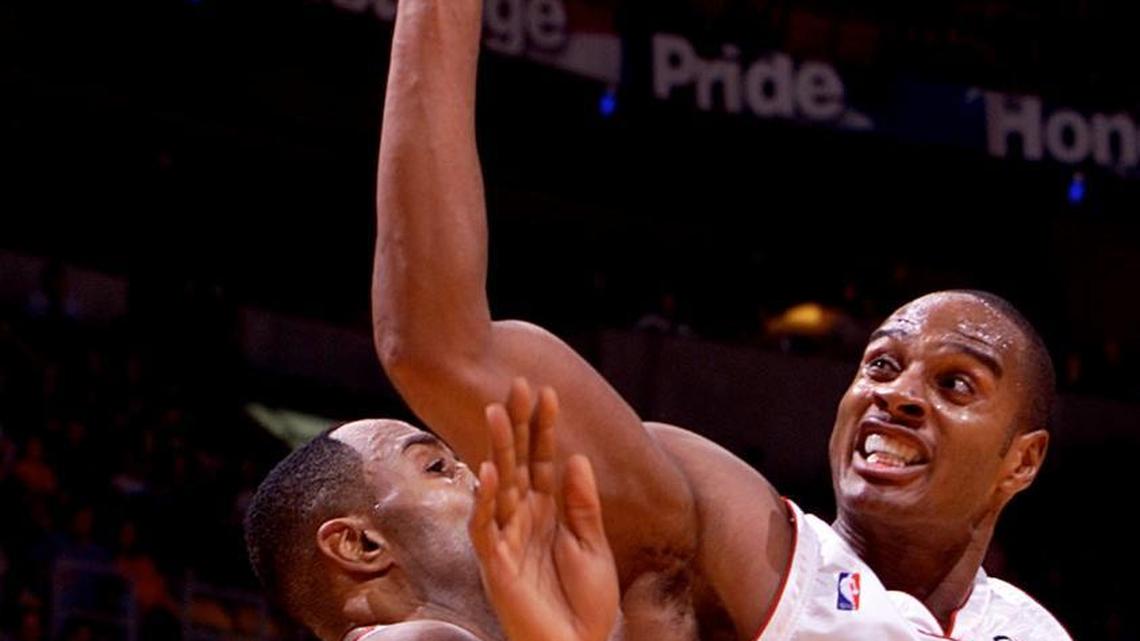 Miami Heat forward LaPhonso Ellis reachs for a rebound in the first half of a game against the Milwaukee Bucks on Dec. 11, 2001.