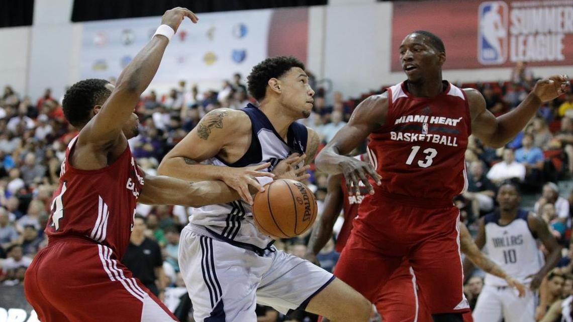 Miami Heat's Matt Williams, left, and Bam Adebayo, right, battle for the ball with Dallas Mavericks' Brandon Ashley during the first half of an NBA summer league basketball game, Tuesday, July 11, 2017, in Las Vegas.