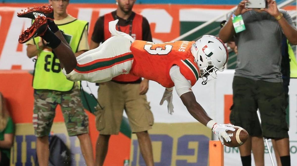 Miami Hurricanes quarterback DeeJay Dallas (13) scores in the fourth quarter against Notre Dame at Hard Rock Stadium on Saturday, November 11, 2017.