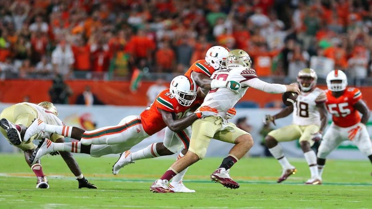 University of Miami Hurricanes linebacker Gerald Willis, 91, and teammate defensive linemen Joe Jackson, 99, sacks Florida State Seminoles quarterback Sean Maguire in the second quarter of an NCAA college football game at Hard Rock Stadium on Sat., Oct. 8, 2016, in Miami Gardens.