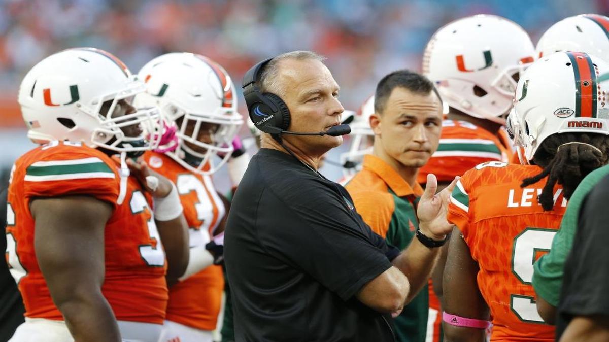 Miami Hurricanes head coach Mark Richt with players on the field as the University of Miami Hurricanes host the University of North Carolina Tar Heels at Hard Rock Stadium on Sat., Oct. 15, 2016.