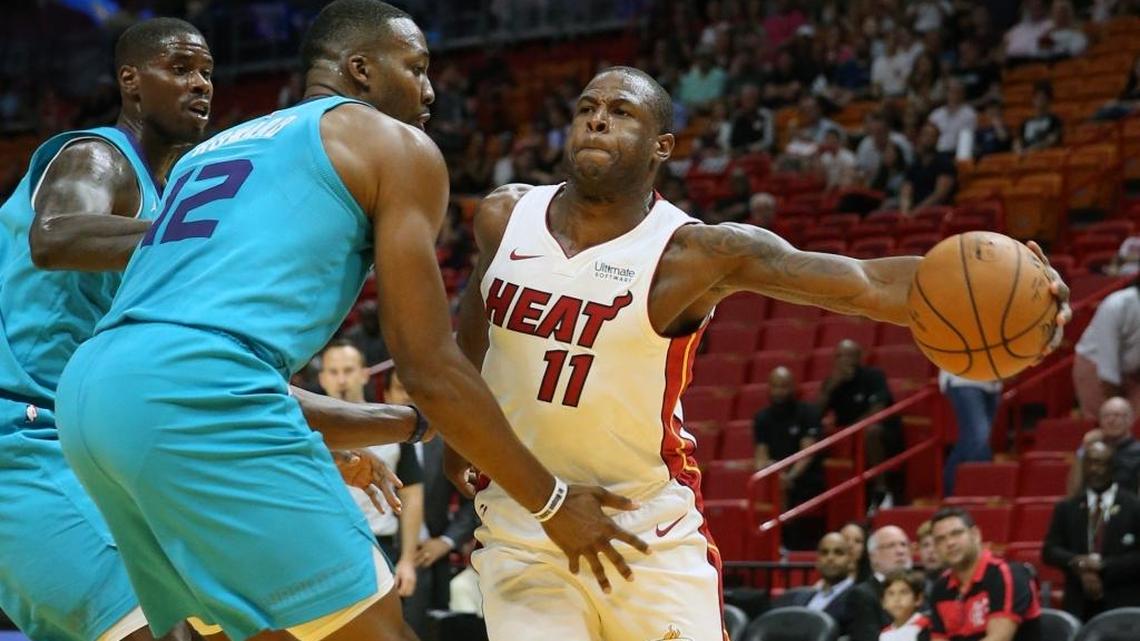 Miami Heat Dion Waiters passes the ball around Charlotte Hornets Dwight Howard in the first quarter at the AmericanAirlines Arena in Miami, Florida, October 9, 2017.
