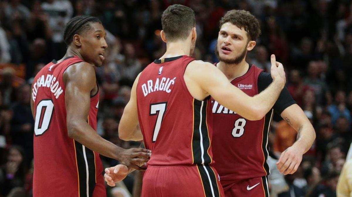 Miami Heat guards Josh Richardson (0), Goran Dragic (7), and Tyler Johnson (8) celebrate a Jan. 7 win against Utah. (AP Photo/Joel Auerbach)
