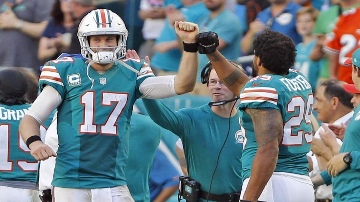 Miami Dolphins quarterback Ryan Tannehill celebrates with Arian Foster after a throw to Kenny Stills that resulted in a touchdown in the fourth quarter at Hard Rock Stadium in Miami Gardens, Florida on Sun., Oct. 23, 2016.
