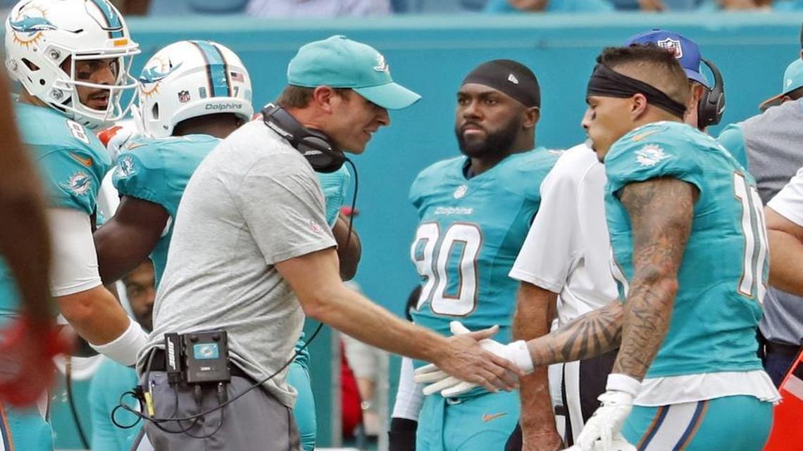 Miami Dolphins head coach Adam Gase congratulates wide receiver Kenny Stills (10) after scoring in the third quarter as the Miami Dolphins host the New England Patriots at Hard Rock Stadium on Sunday, Jan. 1, 2017