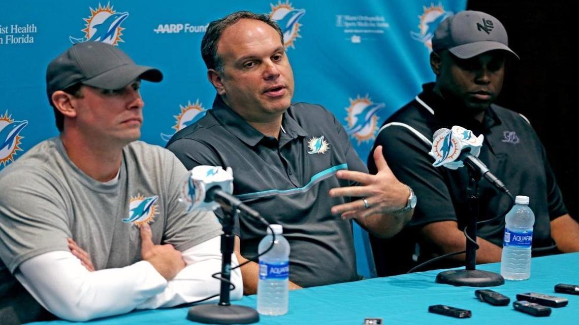 Miami Dolphins Mike Tannenbaum, vice president of football operations, and coach Adam Gase (left) and GM Chris Greer (right), talks to the media at a "season end" press conference at the Miami Dolphins training facility in Davie, Florida, Jan. 11, 2017.