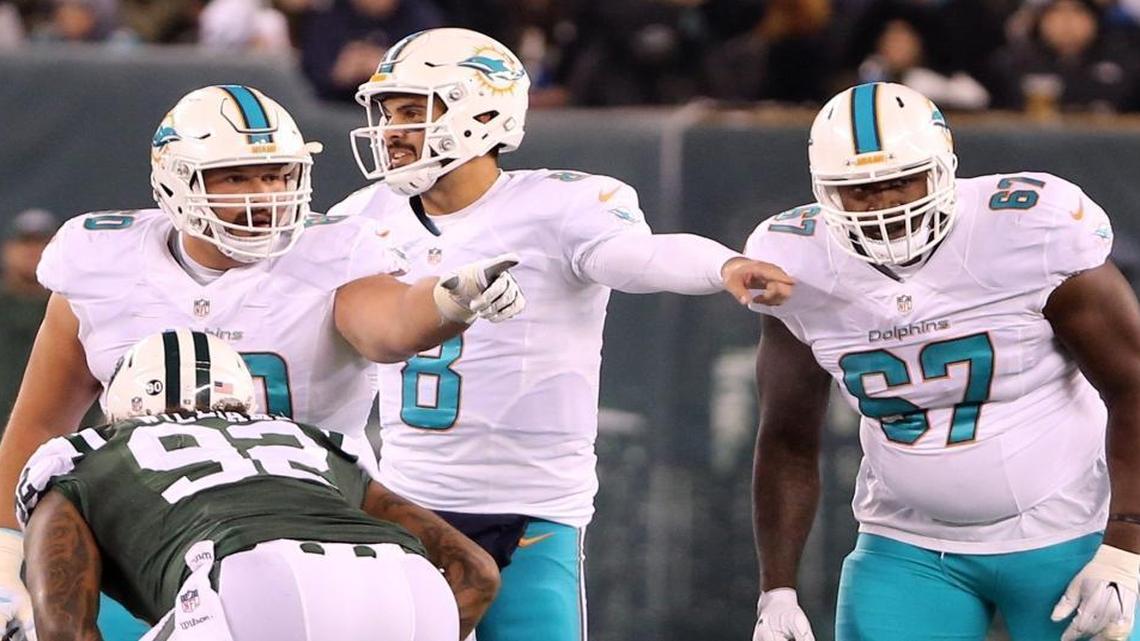 Miami Dolphins center Kraig Urbik, 60, quarterback Matt Moore, 8, and Laremy Tunsil, 67, set the line as they play the New York Jets at MetLife Stadium in East Rutherford, New Jersey on Sat., Dec. 17, 2016.