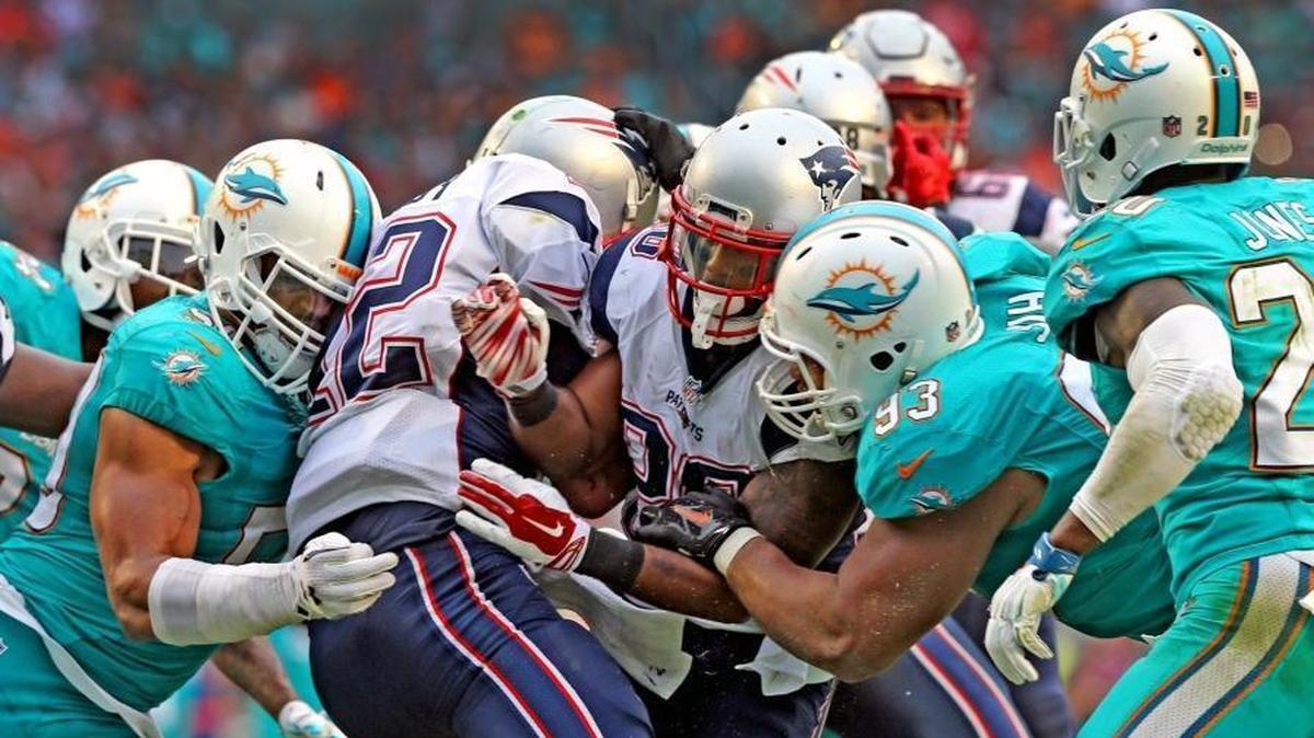 Miami Dolphins defensive line sacks New England Patriots quarterback Tom Brady in the fourth quarter of a game on Jan. 3. The teams play Sunday in Masachusetts.