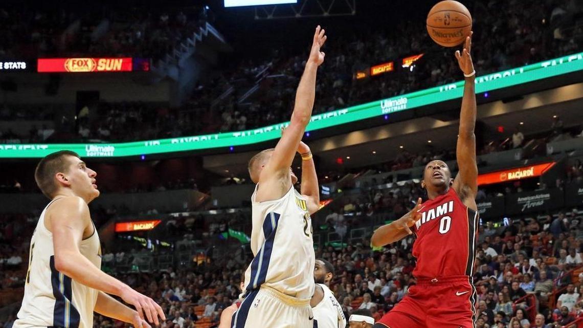 Miami Heat guard Josh Richardson (0) drives to the basket past Denver Nuggets center Mason Plumlee (24) in a game on March 19. Richardson has taken a big jump in his third season.