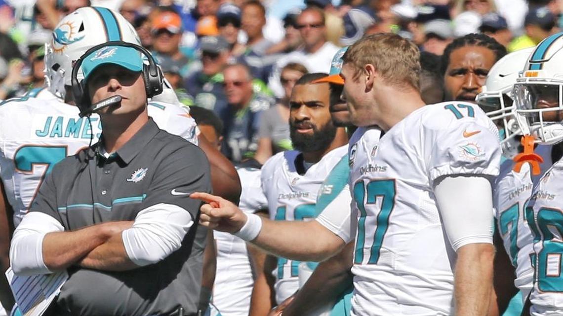 Miami Dolphins quarterback Ryan Tannehill talks with coach Adam Gase in the first quarter as they play the Seattle Seahawks at CenturyLink Field in Seattle, WA, Sun., Sept. 11, 2016.