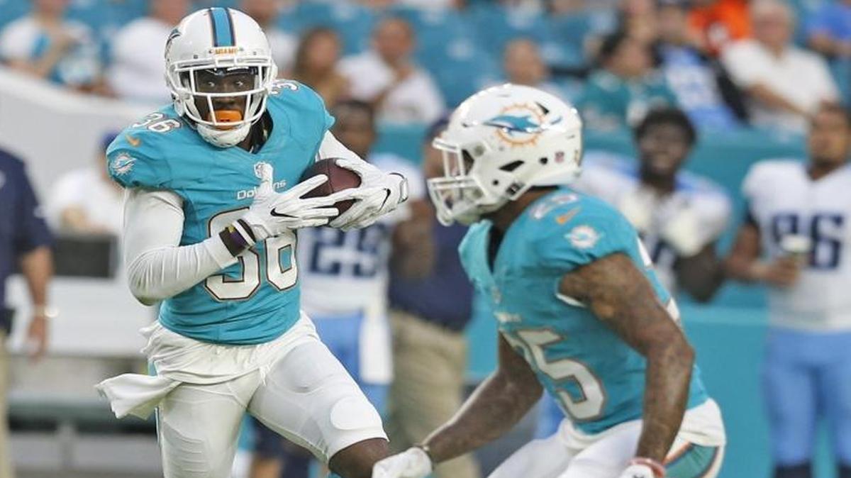 Miami Dolphins defensive back Tony Lippett (36) runs back a pass interception intended for Tennessee Titans wide receiver Justin Hunter (15) in the first quarter as the Miami Dolphins host the Tennessee Titans at Hard Rock Stadium on Thurs., Sept. 1, 2016.
