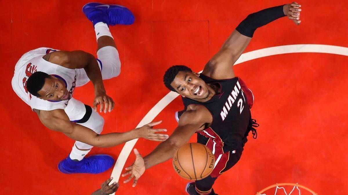 Miami Heat center Hassan Whiteside, right, and Los Angeles Clippers forward Wesley Johnson reach for a rebound during the second half of an NBA basketball game, Sun., Jan. 8, 2017, in Los Angeles. The Clippers won 98-86.