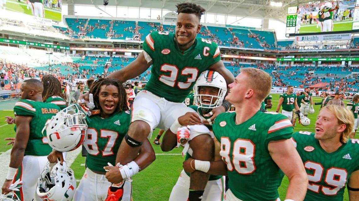 Miami Hurricanes tight end Christopher Herndon IV (23) is carried off by teammates after the University of Miami Hurricanes defeated the Virginia Cavaliers at Hard Rock Stadium on Saturday, Nov. 18, 2017 in Miami.