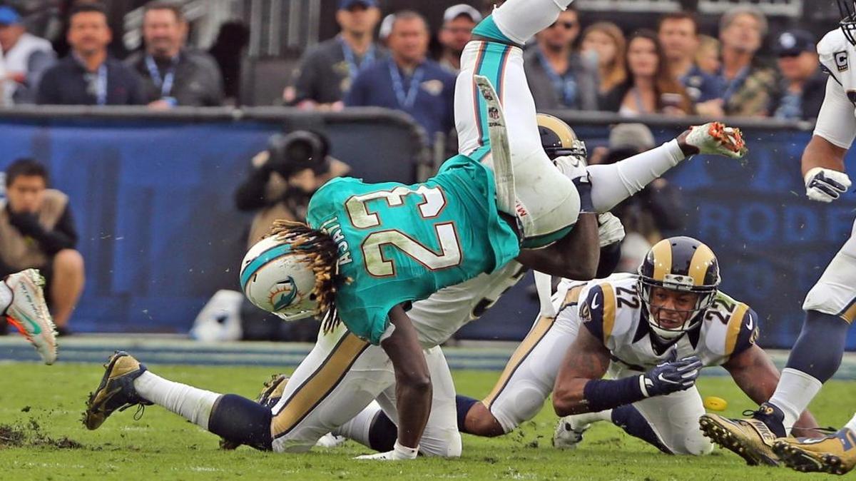 Miami Dolphins running back Jay Ajayi is upened on a second-quarter run as they play the Los Angeles Rams at the Los Angeles Memorial Coliseum in Los Angeles on Nov. 20, 2016.