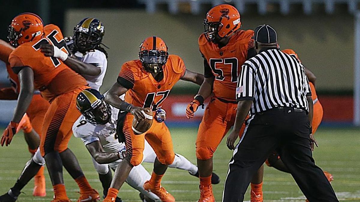 Plantation American Heritage defensive end Andrew Chatfield attempts to make a tackle in an August game against Booker T. Washington. Chatfield took an official visit to UM this past weekend.