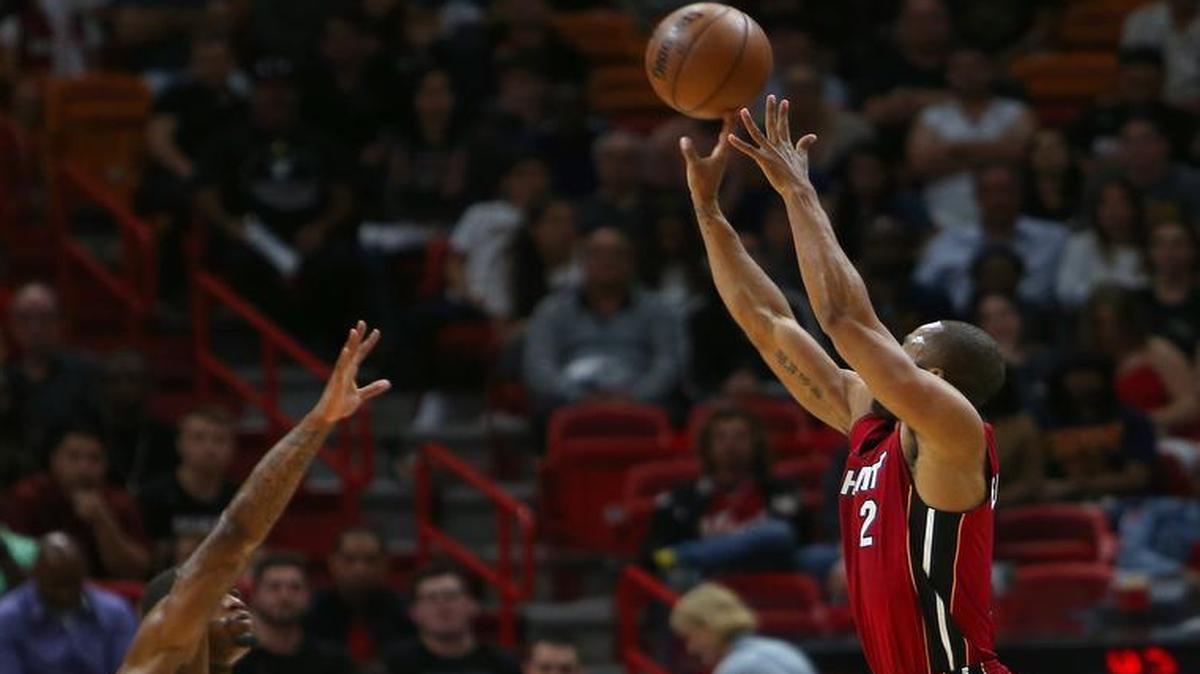Miami Heat guard Wayne Ellington hits a three pointer against Cleveland Cavaliers guard DeAndre Liggins during the fourth quarter of an NBA basketball game at AmericanAirlines Arena in Miami on Sat., March 4, 2017.