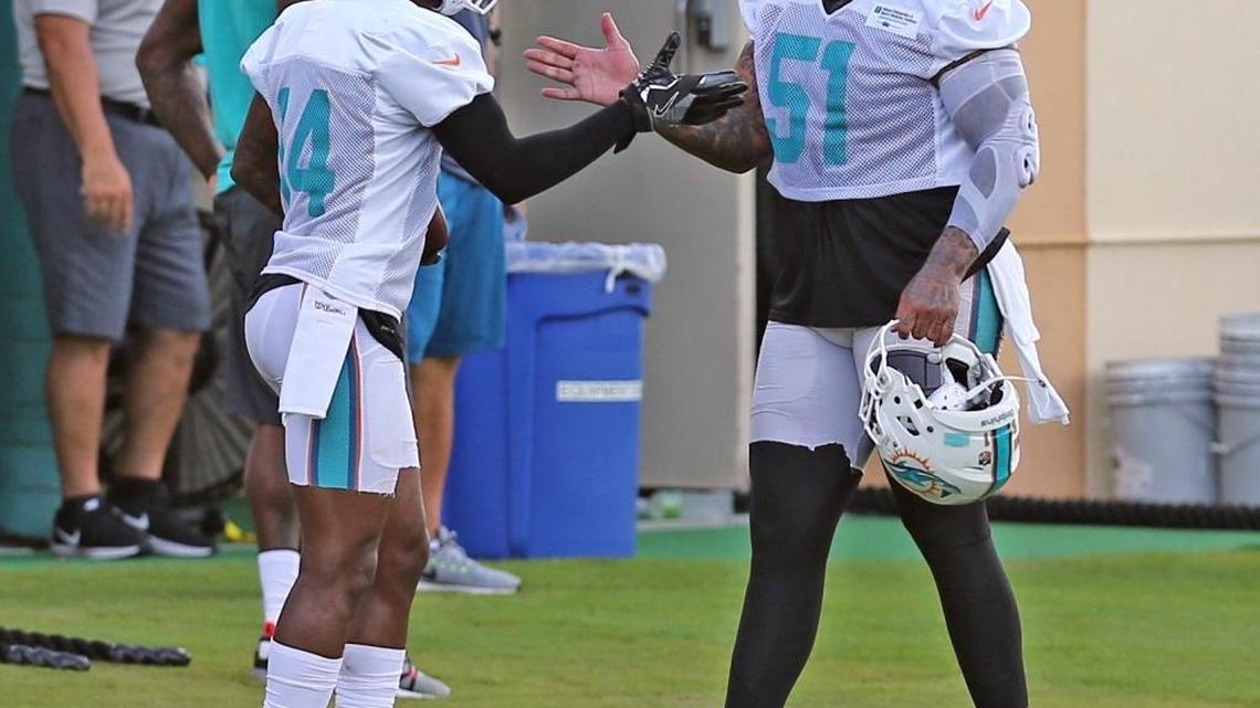 Miami Dolphins Jarvis Landry 14, greets Mike Pouncey 51, on the first day of training camp at the Miami Dolphins facility in Davie, Fl, July 27, 2017.