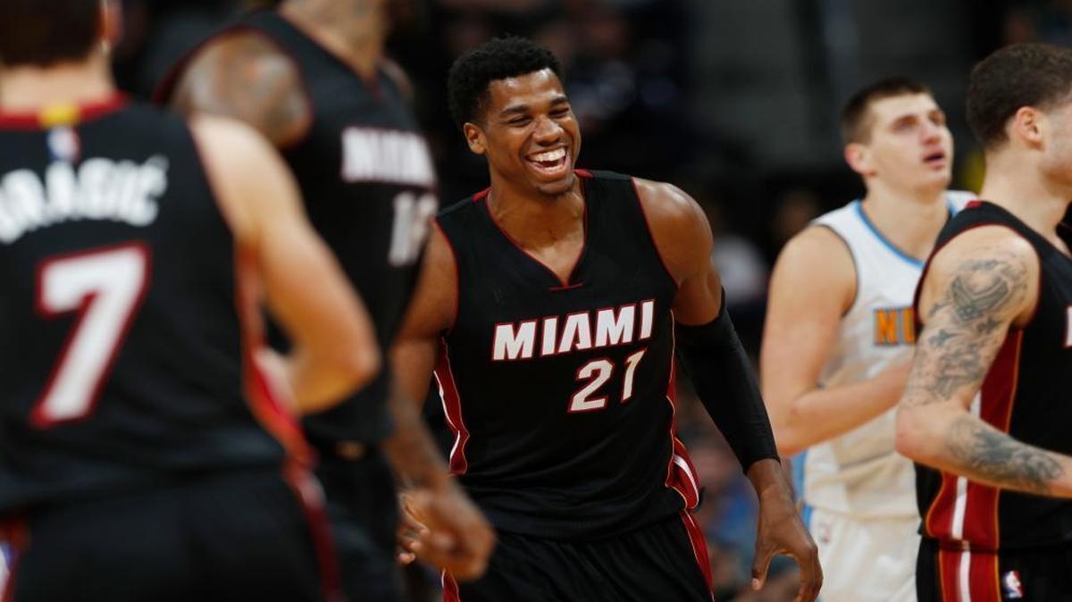 Miami Heat center Hassan Whiteside, center, smiles after hitting a basket against the Denver Nuggets late in the second half of an NBA basketball game Wed., Nov. 30, 2016, in Denver. The Heat won 106-98.