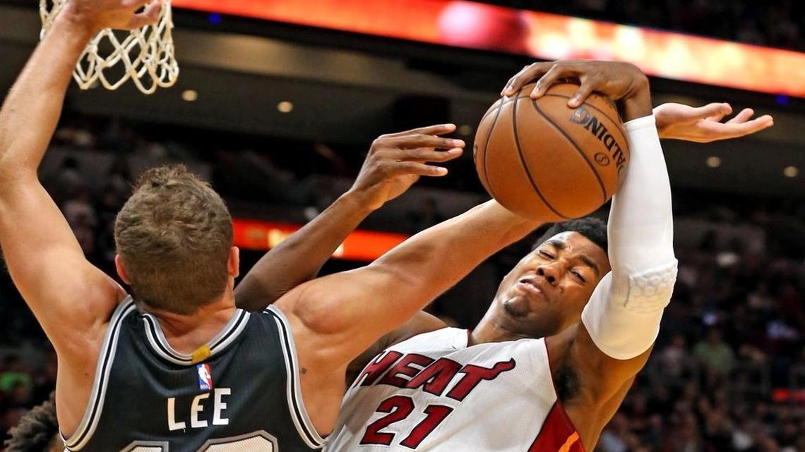 Miami Heat's Hassan Whiteside gets a rebound from San Antonio Spurs' David Lee in the first quarter at the AmericanAirlines Arena in Miami, Florida on Sun., Oct. 30, 2016.