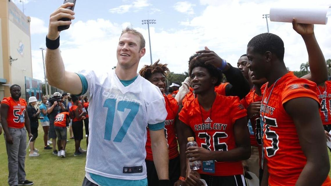 Miami Dolphins quarterback Ryan Tannehill taking a selfie with Miami Carol City Senior High School students after the NFL football minicamp, Thursday, June 15, 2017, at the team's training facility in Davie.