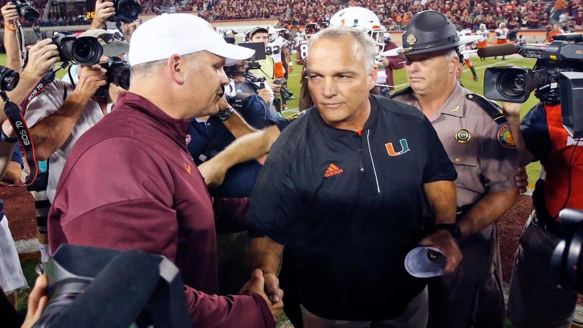 Virginia Tech head coach Justin Fuente, left shakes the hand of Miami head coach Mark Richt after an NCAA college football game at Lane stadium in Blacksburg, Va., Thurs., Oct. 20, 2016. Virginia Tech defeated Miami 37-16.