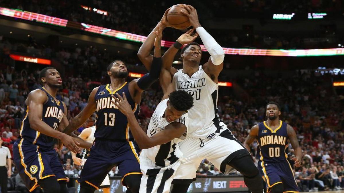 Miami Heat center Hassan Whiteside pulls down a rebound against Indiana Pacers forward Paul George (13) during the fourth quarter of an NBA basketball game at AmericanAirlines Arena in Miami on Wed., Dec. 13, 2016.