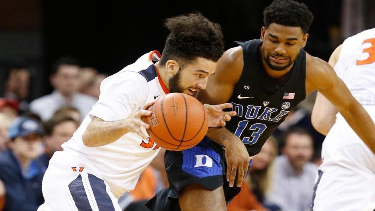 Virginia guard London Perrantes, left, drives past Duke guard Matt Jones (13) during the first half of an NCAA college basketball game in Charlottesville, Va., Wed., Feb. 15, 2017.
