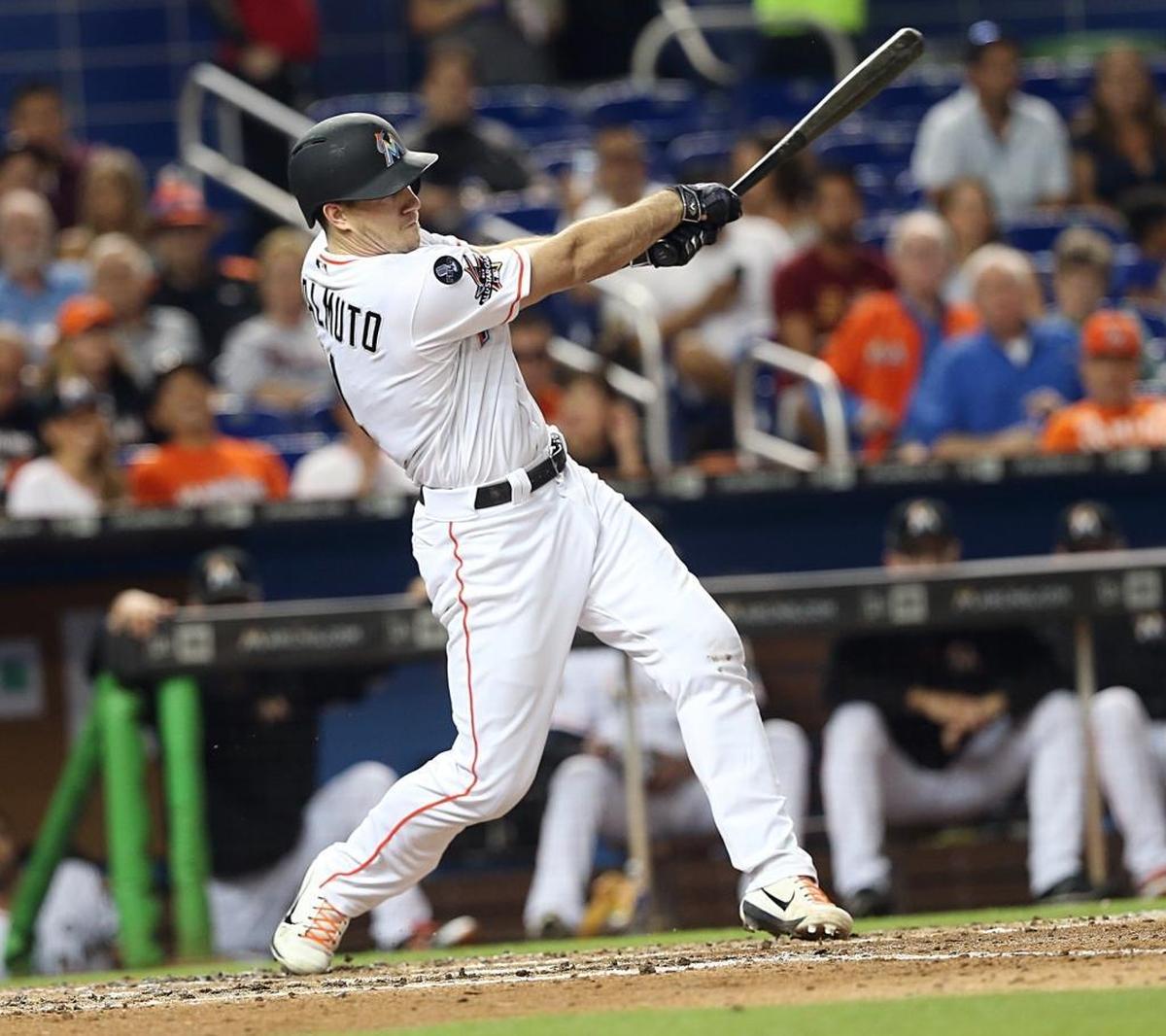 Marlins catcher J.T. Realmuto hits a double against the the Mets in a game in September.