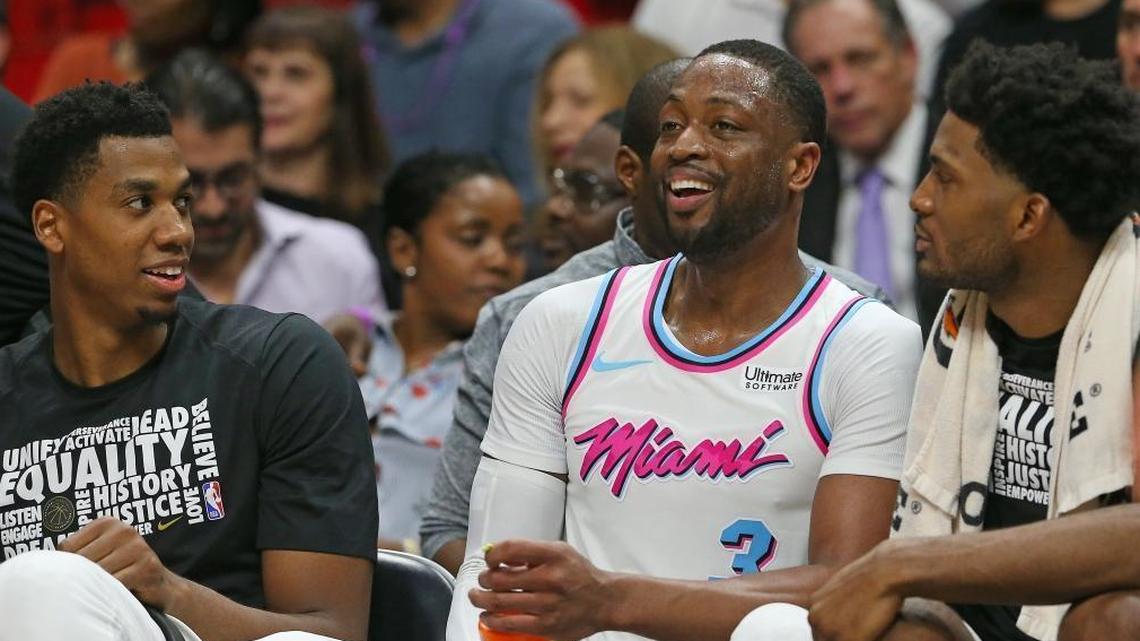 Miami Heat guard Dwyane Wade talks with teammates Hassan Whiteside, left, and Justise Winslow during Friday’s game against Milwaukee.