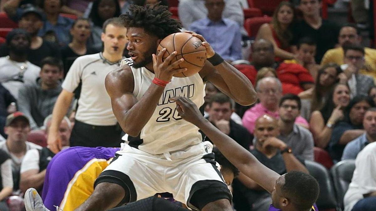 Miami Heat forward Justise Winslow holds on to the ball against Lakers' Luol Deng in the fourth quarter of the Miami Heat and Los Angeles Lakers game at AmericanAirlines Arena in Miami on Thurs., Dec. 22, 2016.