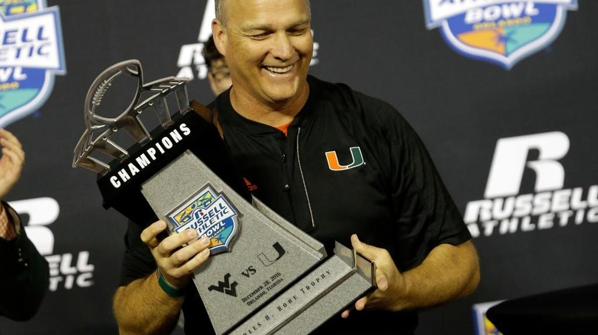 Miami head coach Mark Richt holds up the championship trophy after defeating West Virginia 31-14 in the Russell Athletic Bowl NCAA college football game, Wednesday, Dec. 28, 2016, in Orlando, Fla.