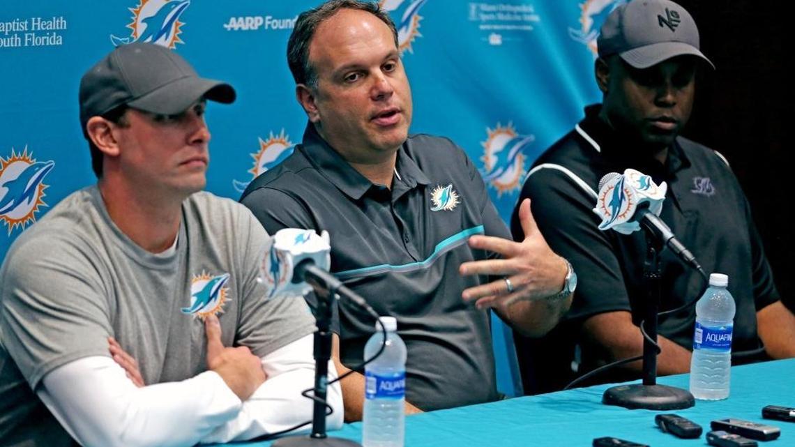 Miami Dolphins Mike Tannenbaum, vice president of football operations, and coach Adam Gase (left) and GM Chris Grier (right).