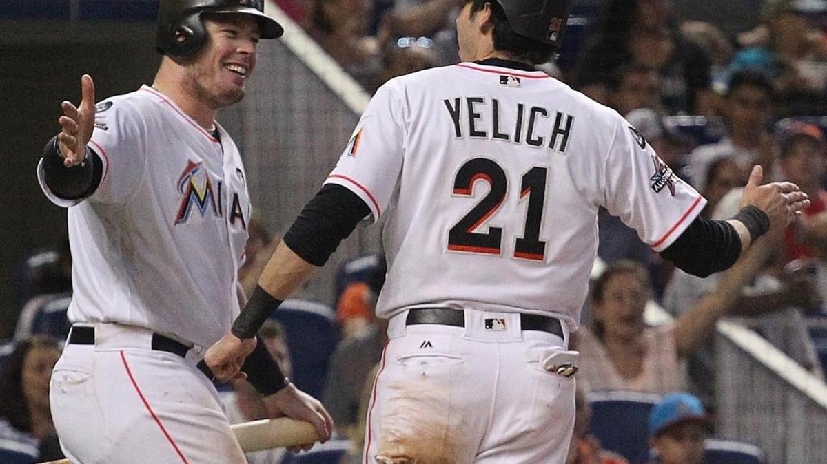 Justin Bour and Christian Yelich celebtrate a Yelich RBI in the final game of the 2017 season. The Marlins prefer to keep both players, but nothing is definite.